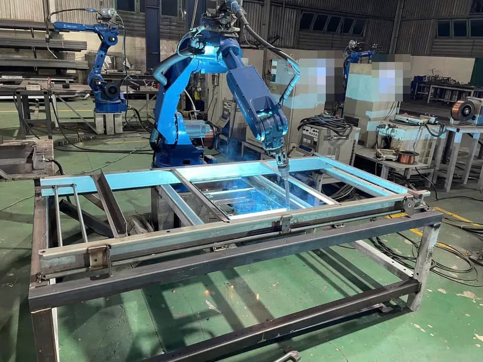 Representative robot welding of a steel frame at a partner factory